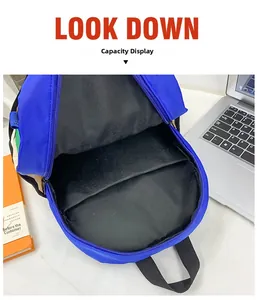 Detail view of the spacious inner compartment and pocket of the blue canvas kids backpack