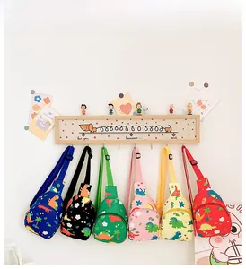 Close-up of cute cartoon dinosaur crossbody bags in six vibrant colors for children