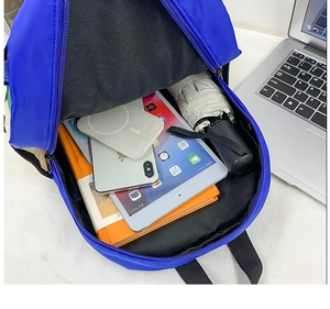 Top view of blue canvas backpack showing large capacity for tablet, umbrella, and books