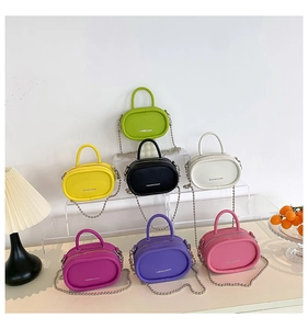 Mini oval chain bags displayed in multiple colors including green yellow and pink