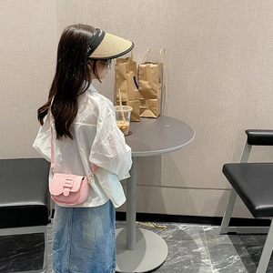 Girl's pink mini crossbody PU bag with lychee texture and matching buckle detail