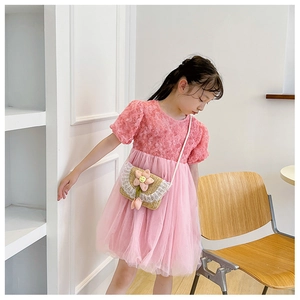 Detail of pink floral straw crossbody bag on sweet princess dress for little girls