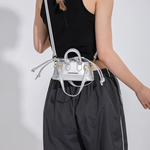 Silver metallic mini crossbody bag with drawstring design and top handle for women