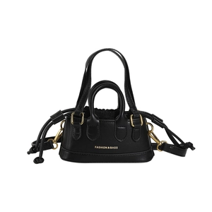 Mini black handbag with white logo and gold hardware on white background
