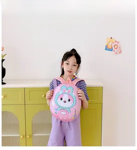 Pink egg-shaped toddler backpack with cute bunny graphics being held by a small child