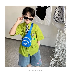 Detail of blue mini chest bag for kids with white DOD letter print and adjustable strap