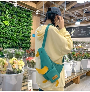 Détail du sac bandoulière canard bleu sarcelle en toile avec bec jaune et sangle