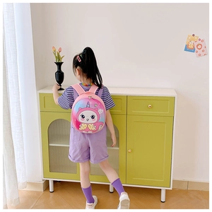 Pink cartoon unicorn hard shell toddler backpack shown on child back with starry sky design