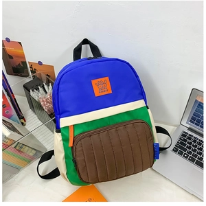 Detail of color-block backpack showing Happy Rabbit patch and durable nylon texture