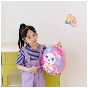 Pink eggshell toddler backpack with cute unicorn pattern shown by a little girl
