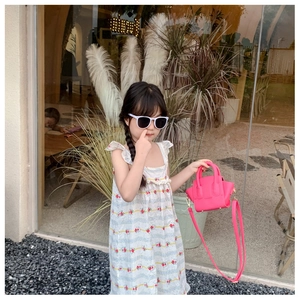 Pink leather luggage style mini handbag paired with floral dress for girls outfit