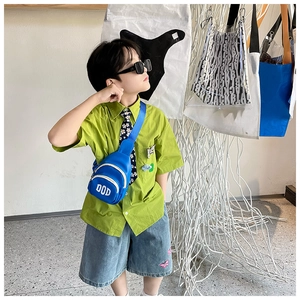 Detailed close-up of a blue kids' fashion chest bag with white DOD letters on a stylish boy