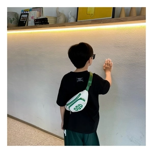 Detail showing white and green kids crossbody bag with DOD lettering on the back of model