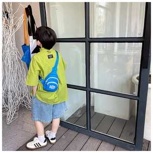 Close-up of stylish blue kids chest bag with DOD logo paired with summer fashion outfit