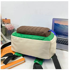 Detail of color-block canvas backpack featuring reinforced base and adjustable straps