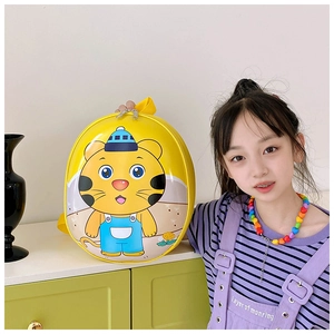 Close-up of yellow hardshell toddler backpack featuring a cute cartoon tiger character