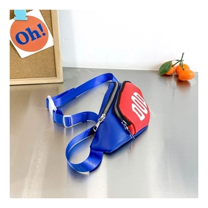 Detail view of the vibrant blue and red contrast crossbody chest bag for kids with DUD logo