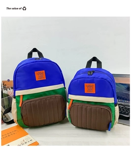 Detail of color-block canvas backpacks in two sizes featuring Happy Rabbit embroidery