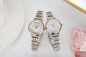 Elegant ladies quartz watches with crystal markers displayed with flowers and ceramic decor