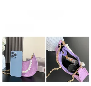 Internal view of purple crocodile texture mini bag with large pearls and golden chain strap