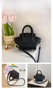 Detail of black mini basket bag with lychee texture and adjustable shoulder strap