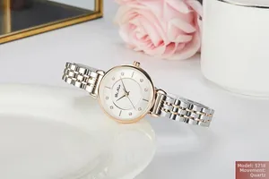 Detail of quartz watch for women with rose gold steel band and diamond markers