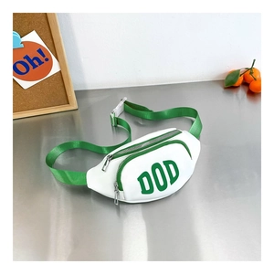 Detail view of stylish kids cross-body chest bag with green DOD lettering and leather texture