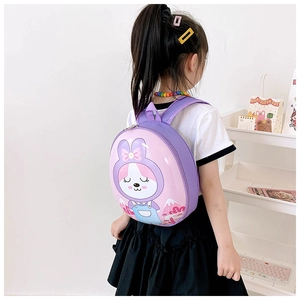 Detail view of purple hardshell bunny backpack on child showing ergonomic fit and back profile