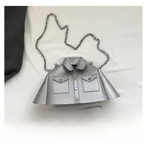 Detailed view of silver creative jacket-shaped chain bag next to a smartphone for size reference