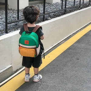 Kids lightweight canvas backpack featuring a vibrant multi-color patchwork design and rabbit logo