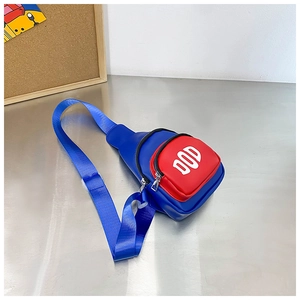 Detail of blue and red PU leather kids chest bag featuring DOD letter print and strap