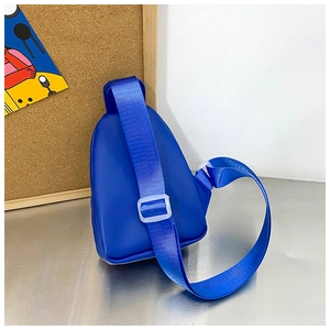 Detail of blue children's chest bag with adjustable woven strap and glossy PU material