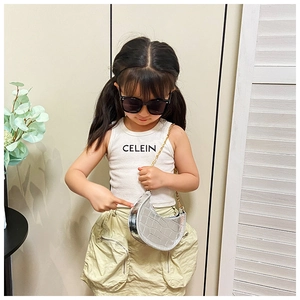Silver crescent kid's bag with crocodile texture and gold chain worn by child model