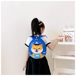 Rear view of a blue cartoon dog hardshell backpack worn by a toddler child on white background