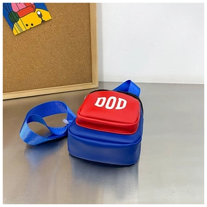 Detail of red zipper pocket and white DOD lettering on blue PU leather crossbody bag