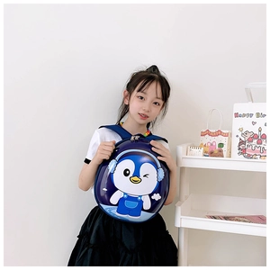 Toddler hardshell backpack featuring a cute cartoon penguin character on a navy surface