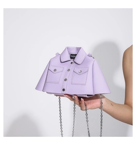 Detail of lavender jacket-shaped bag featuring dual pockets, buttons and silver chain