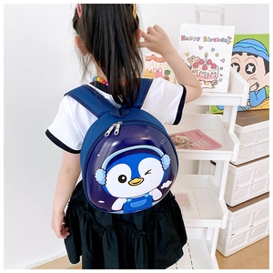 Detail view of a cute blue penguin hard shell backpack for kids worn by a small child