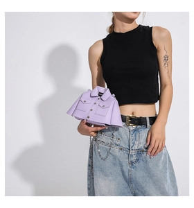 Close-up of lavender leather jacket-shaped bag with silver chain on model outfit