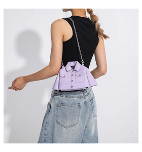 Detailed close-up of a purple jacket-shaped crossbody bag with silver chain strap
