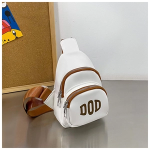 Close-up of white PU leather kids chest bag with DOD letters and brown nylon straps