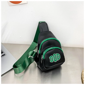 Detail of black PU kids chest bag with neon green edges and DOD letter print on front
