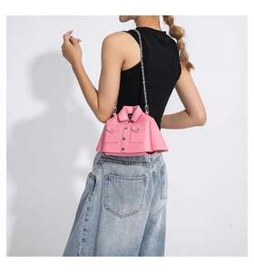 Detailed view of pink jacket-shaped creative crossbody bag with silver chain strap