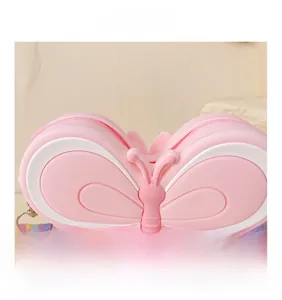 Detailed macro view of pink silicone butterfly bag with rainbow fabric strap and zipper