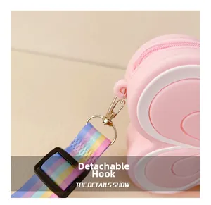 Detail view of pink silicone butterfly bag showing the detachable metal hook and rainbow strap