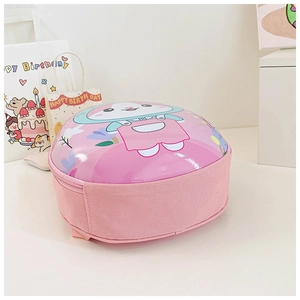 Close-up of pink hardshell kids backpack with cute cartoon rabbit on a desk