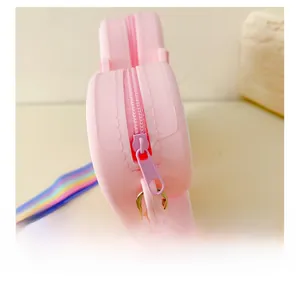 Close-up of pink silicone bag showing the smooth zipper closure and rainbow strap detail