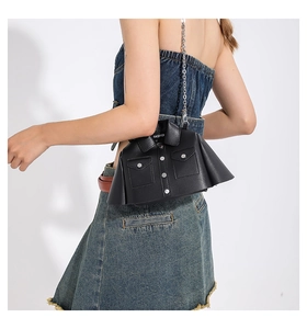 Detailed back view of a creative black jacket shaped crossbody bag with silver chain