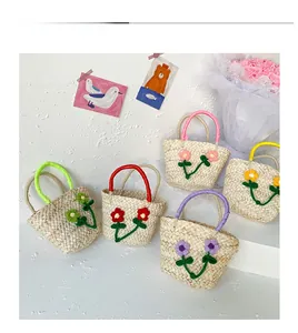 Detail display of mini woven straw handbags with handmade crochet flowers in various colors