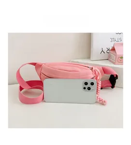 Marsupio rosa in tela per bambini con smartphone per il confronto delle dimensioni
